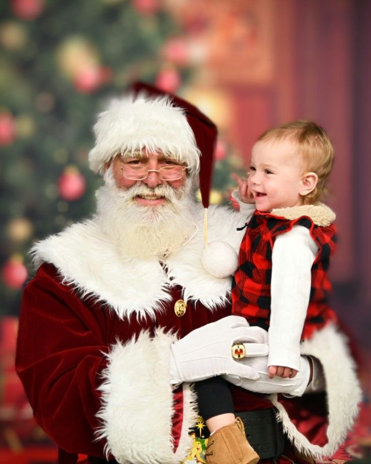 Santa Tony smiling with a happy toddler